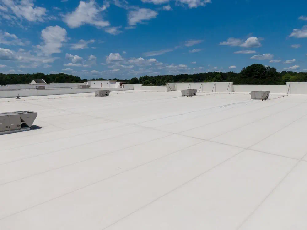 Flat commercial roof inspection in Raleigh NC after heavy rain